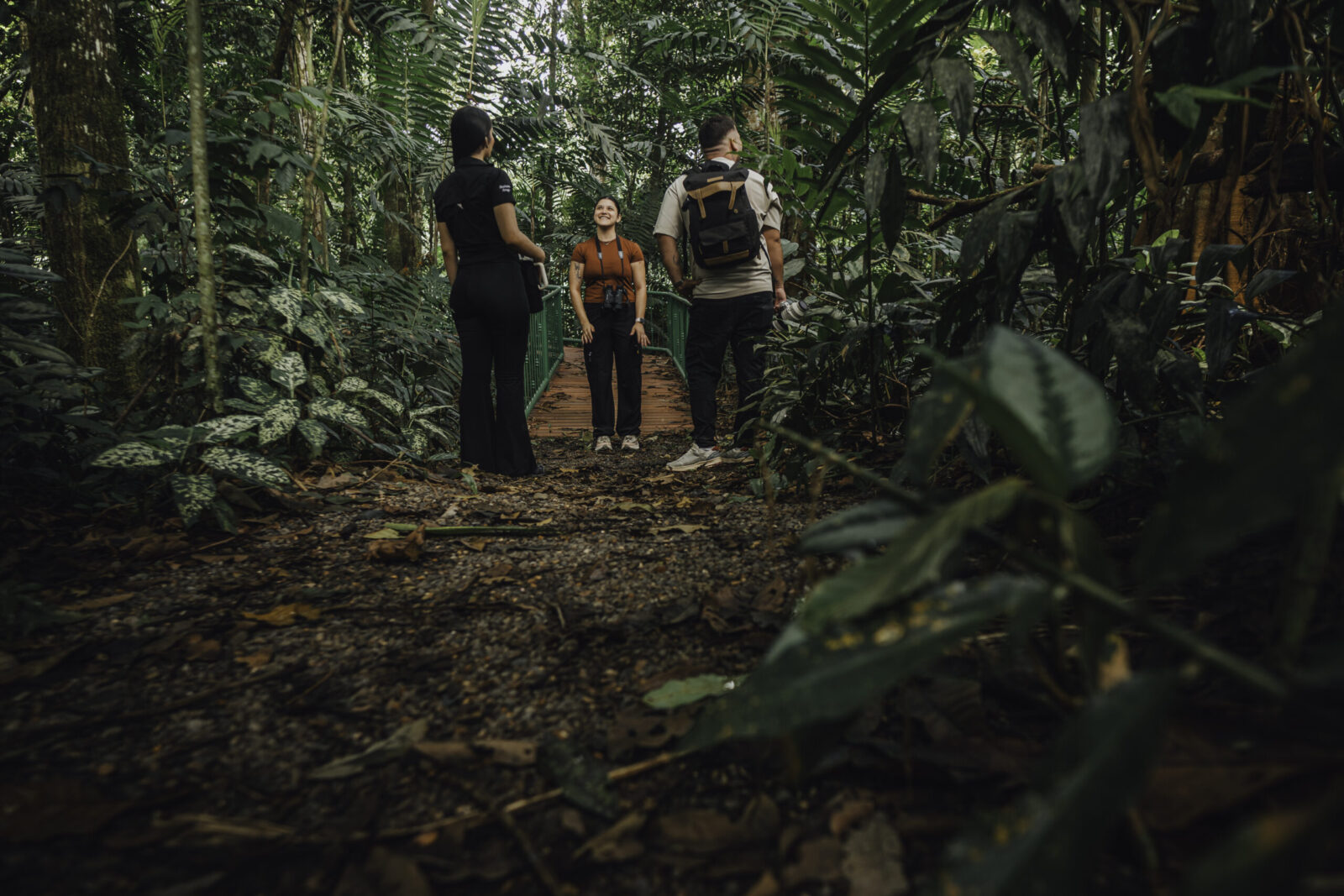 Group on a guided birdwatching tour in La Fortuna walking through rainforest trails